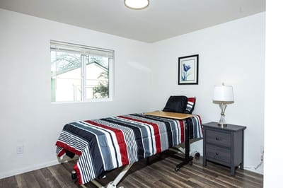 Cozy private resident room with bed and bedside table