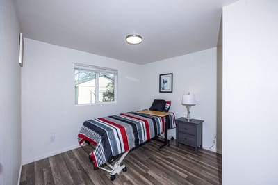 Private resident room with a bed and lamp