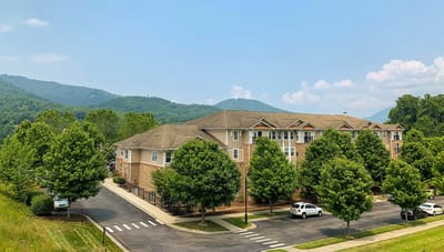 Exterior view of Givens Great Laurels with mountains in the background