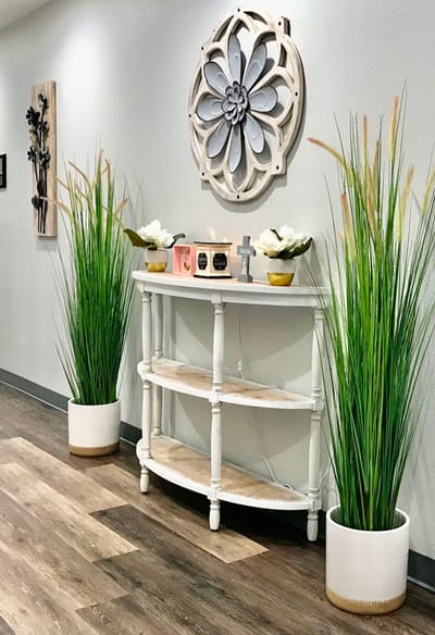 Decorative hallway with plants and wall art