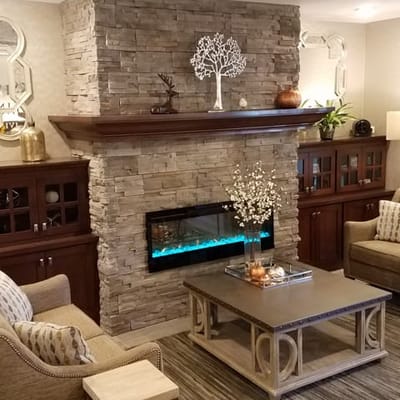 A cozy common area with a fireplace and seating