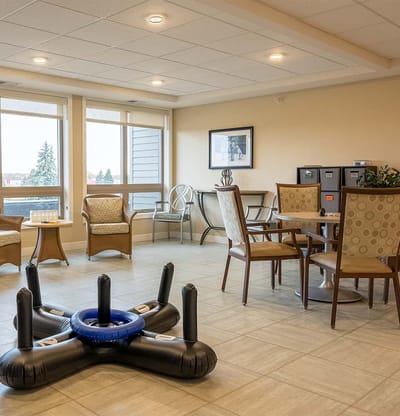 Common area with seating and tables in a senior living facility