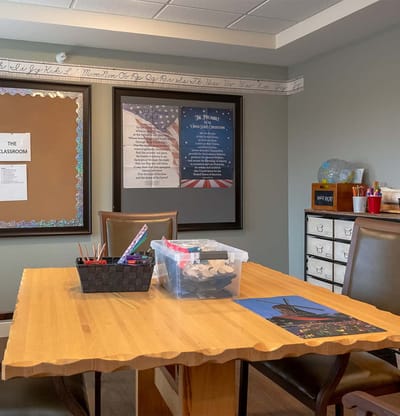 A classroom area with tables and supplies set up