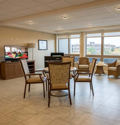 Bright common area with seating and a TV
