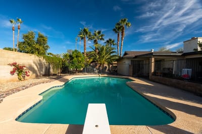 Inviting pool area surrounded by palm trees