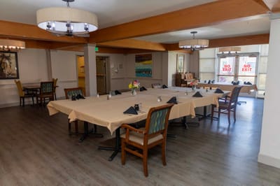 Dining area with tables set for residents