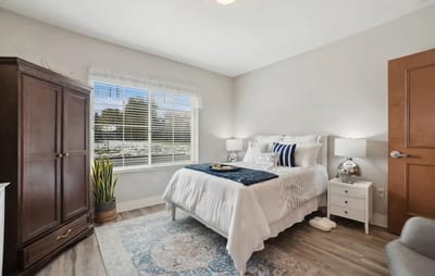 Brightly furnished resident bedroom with natural light