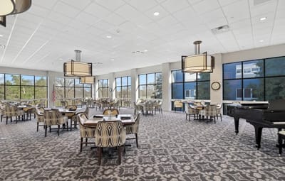 Bright dining room with modern furnishings and large windows