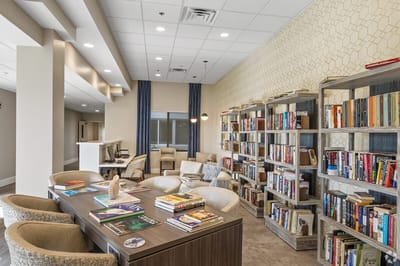 Cozy interior common area with bookshelves and seating