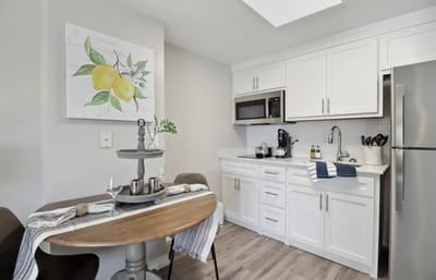 Modern kitchen with dining table and lemon art