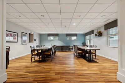 Spacious common area with tables and chairs