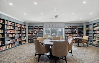 Well-lit library with bookshelves and seating