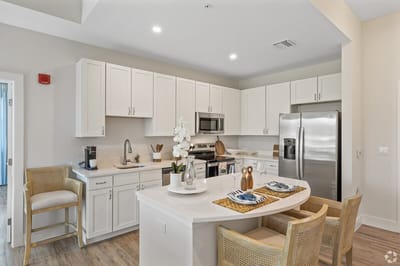Modern kitchen layout with white cabinets and appliances