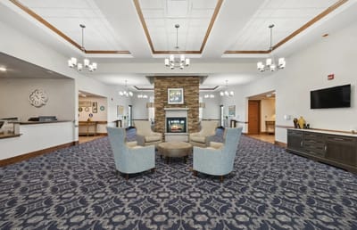 Bright common area with cozy seating and a fireplace