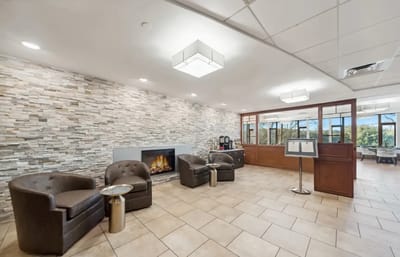 A cozy lounge area with seating and a fireplace