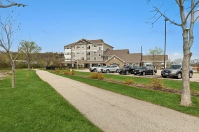 A view of the assisted living facility's exterior and parking area