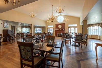 Dining room with elegant decor and tables set for residents