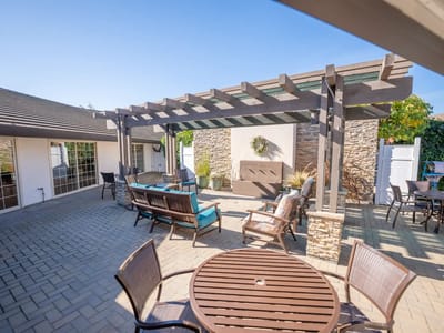 Outdoor seating area with pergola and landscape