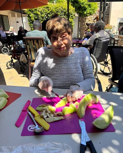 Resident preparing food in an outdoor activity area
