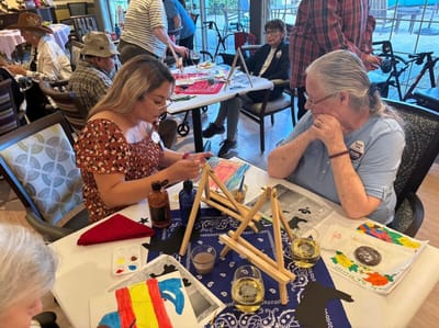 Residents participating in an art activity with staff