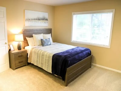 A well-furnished private room with a bed and window