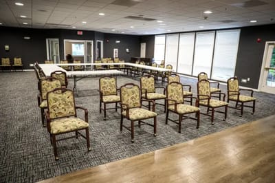 Empty activity room with chairs and tables arranged