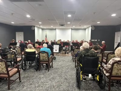 Residents enjoying a music performance in a common area