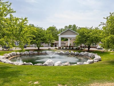 Exterior view of a peaceful pond and building entrance