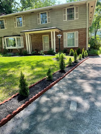 Exterior view of a senior living facility with landscaped pathway