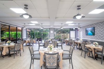 Bright dining room with tables set for meals