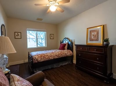 Cozy private resident room with a bed and dresser