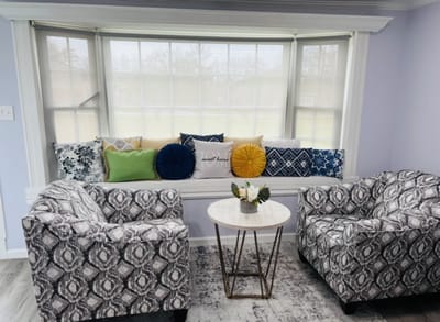 Cozy sitting area with patterned chairs and colorful cushions