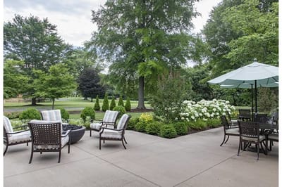 Outdoor patio area with seating and greenery