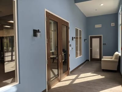 Bright interior hallway with seating and large windows