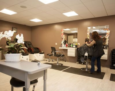 A resident receiving hair service in the salon