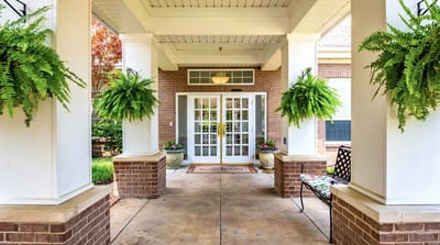 Welcoming entrance with potted plants and double doors