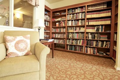 Cozy reading corner in a library with bookshelves