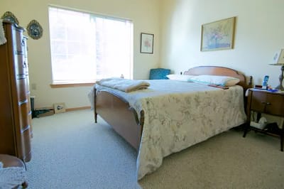 A well-furnished private room with a bed and window