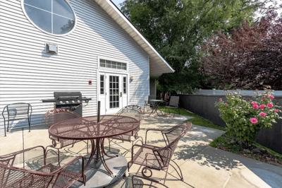 Outdoor patio area with seating and flowers