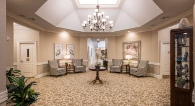 Lounge area with chairs and a chandelier