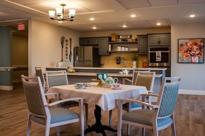 Bright dining area with table settings and bakery theme