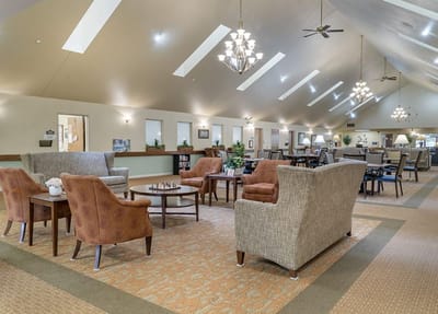 Bright common area with seating and large windows
