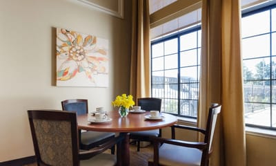 Bright common area with a table and flowers