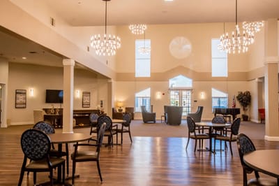 Bright common area with seating and chandeliers