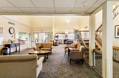 Bright lobby area with seating and staircase