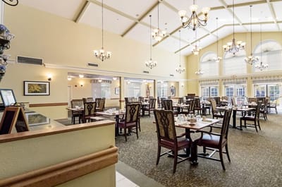 Bright dining room with large windows and elegant decor
