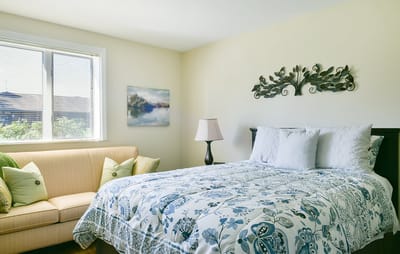 Cozy bedroom with a double bed and couch
