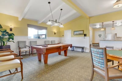 Bright common area with a pool table and seating