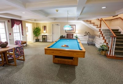 Interior game room with a pool table and seating