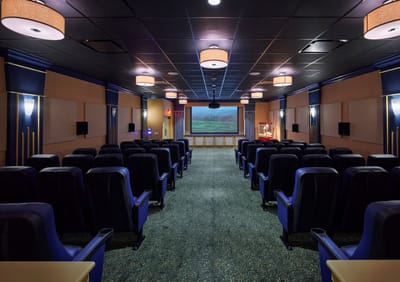 Interior view of a theater with seating and large screen